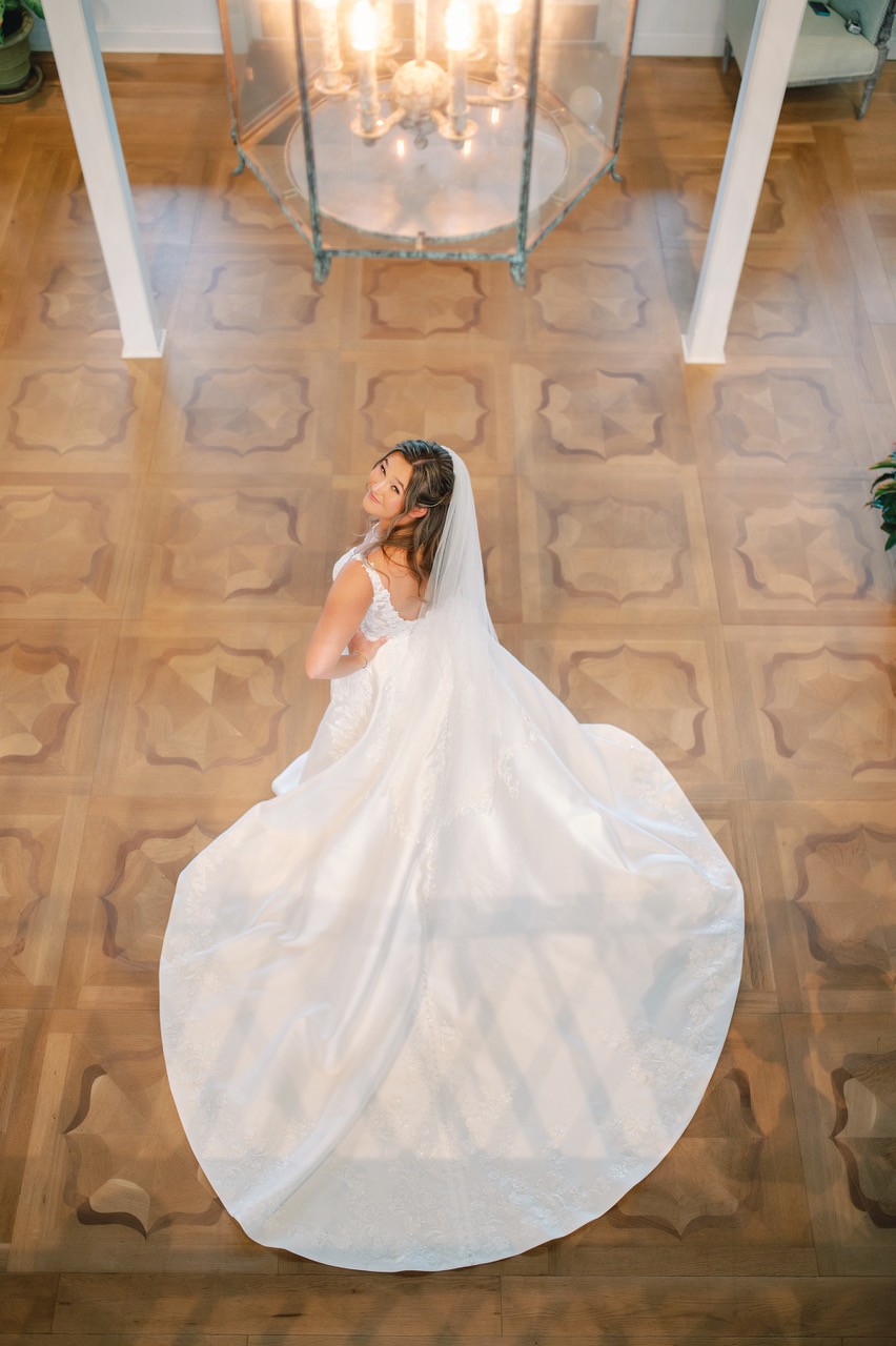 Elegant overhead view of bride with circular train and warm lighting at The Sanderling Resort.